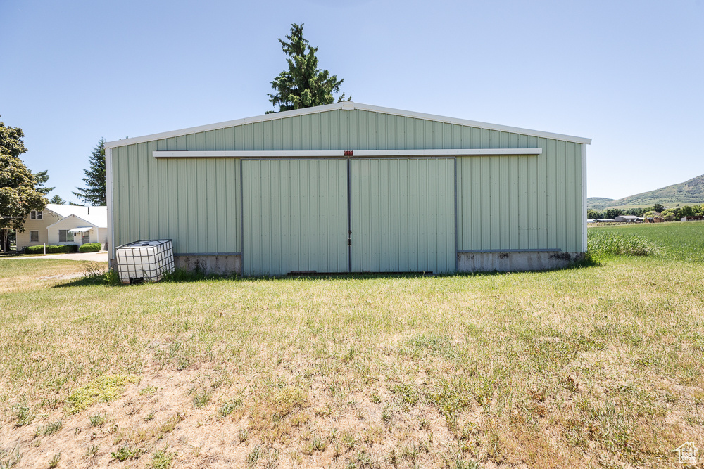 View of pole building featuring a yard