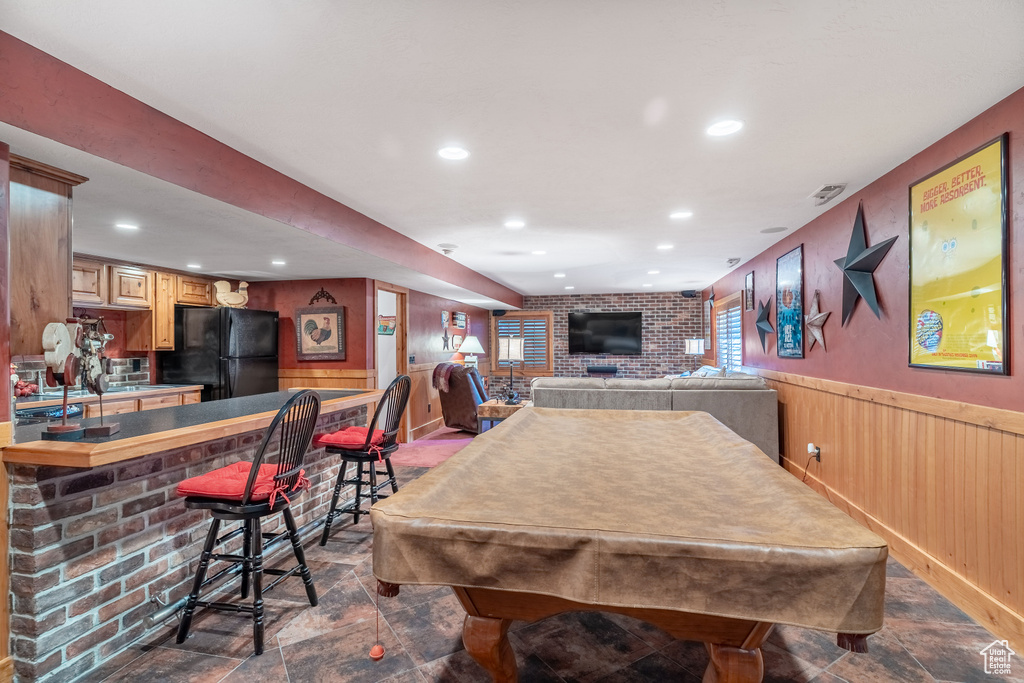 Recreation room featuring dark stone finish flooring, a dry bar, a wainscoted wall, recessed lighting, and billiards table