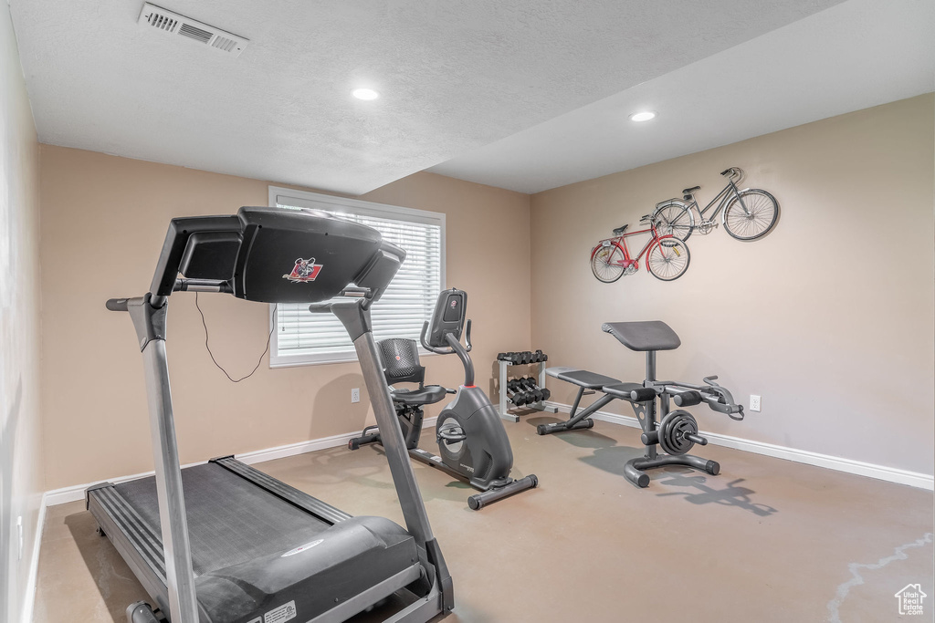Workout room featuring recessed lighting, baseboards, a textured ceiling, and carpet floors