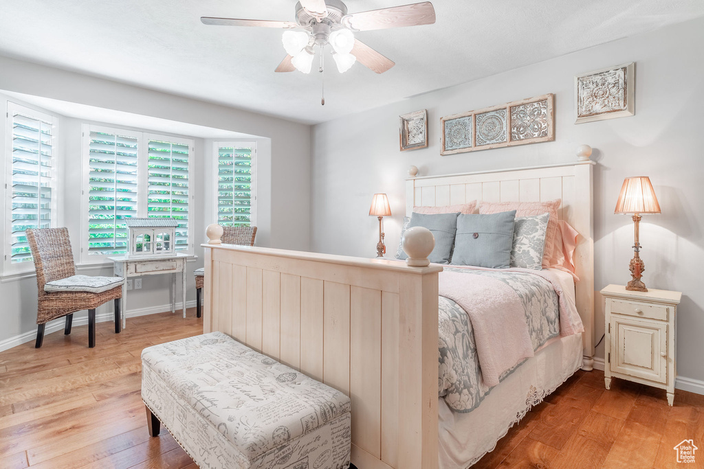 Bedroom with light wood-style floors, baseboards, and ceiling fan