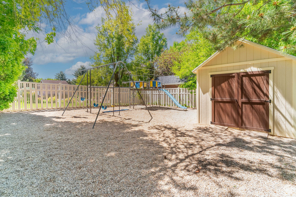 View of jungle gym featuring a fenced backyard