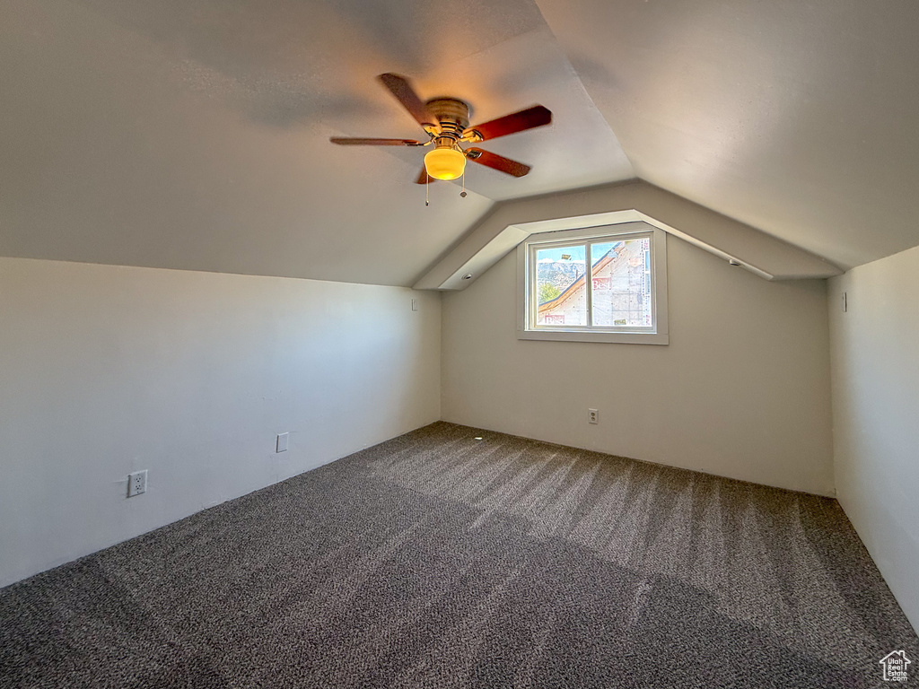 Additional living space with carpet, lofted ceiling, and ceiling fan
