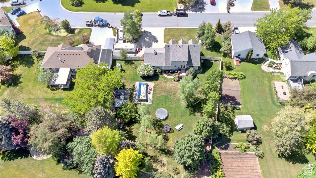 Aerial view of property and surrounding area featuring nearby suburban area