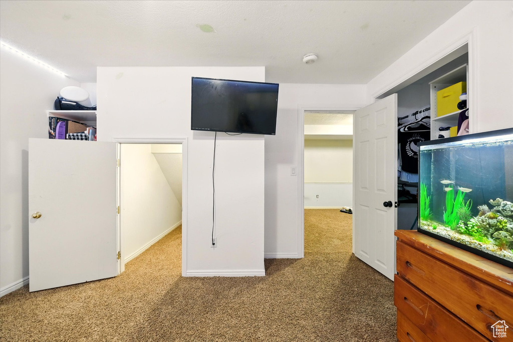 Carpeted bedroom featuring baseboards