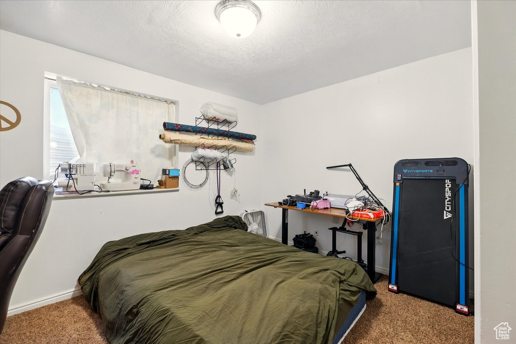 Carpeted bedroom featuring baseboards