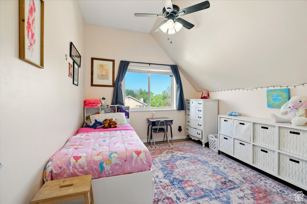 Bedroom featuring vaulted ceiling, a ceiling fan, and baseboards