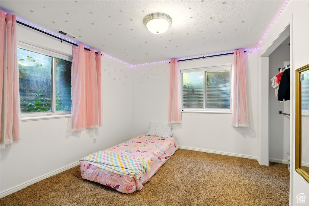 Carpeted bedroom with baseboards