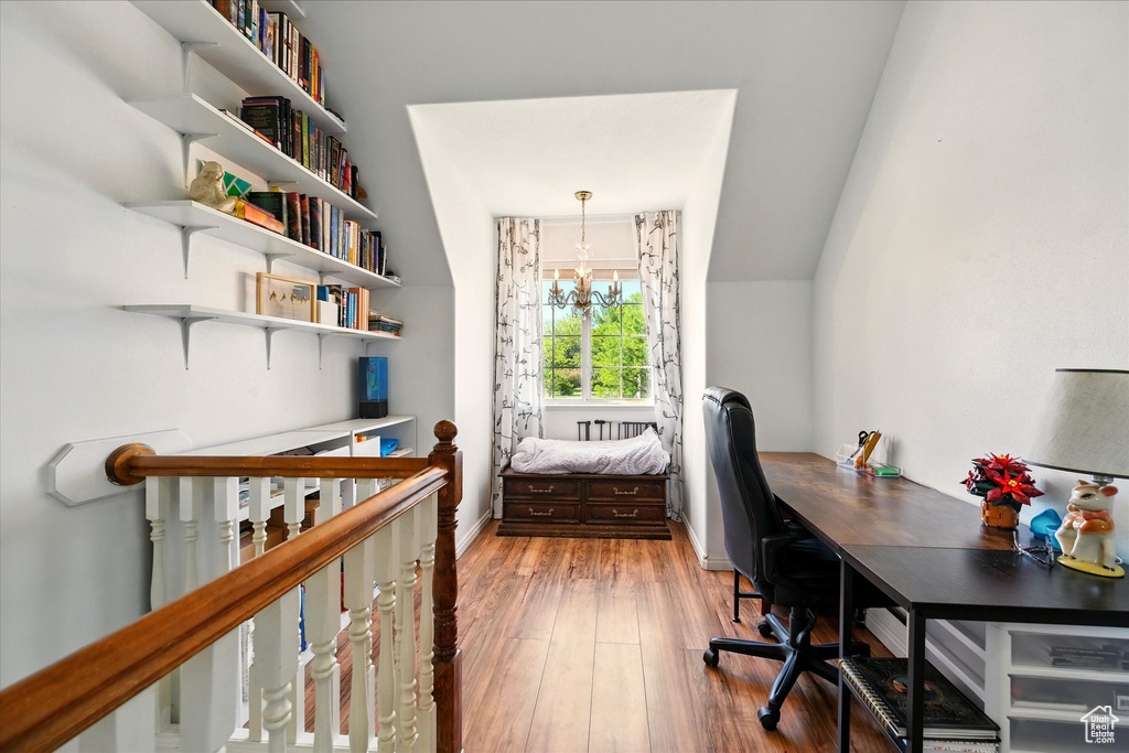 Office area featuring a chandelier, wood finished floors, and baseboards