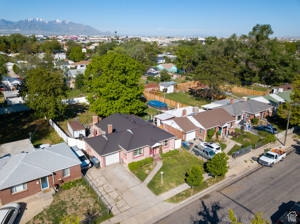 Aerial view of residential area featuring a mountainous background