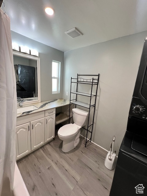 Bathroom with toilet, wood finished floors, and vanity