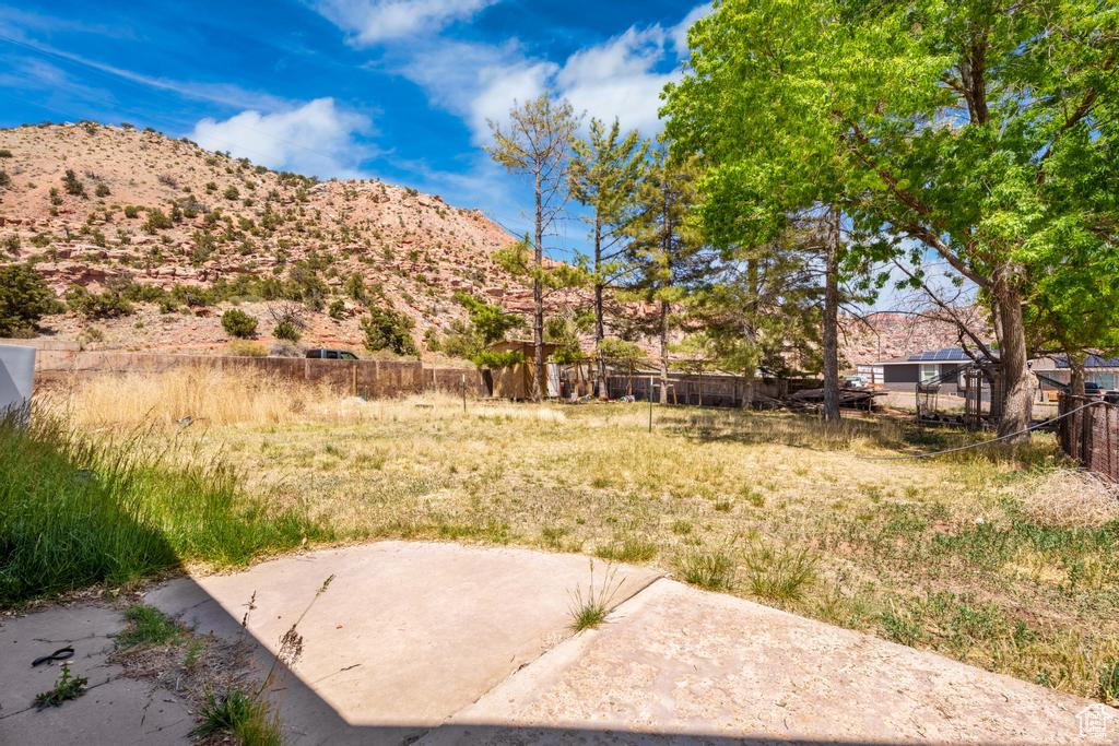 View of yard with a mountain view and a patio area