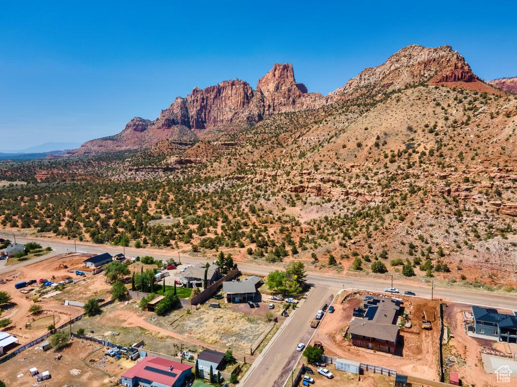 Aerial view of property's location featuring a mountainous background and a desert landscape