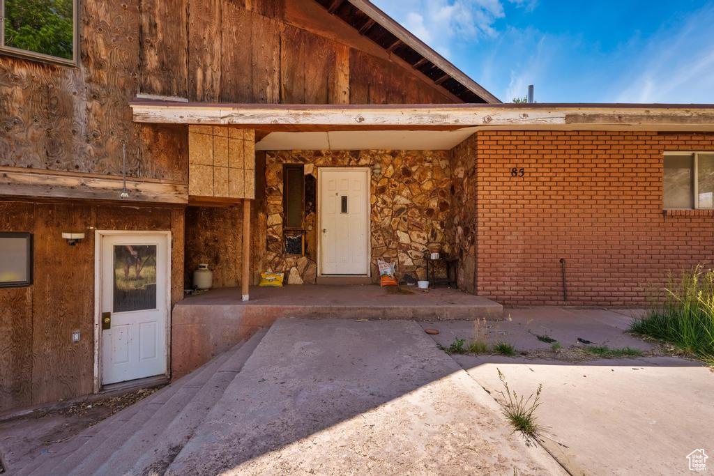 View of exterior entry featuring stone siding