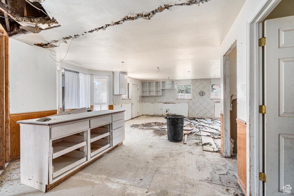 Kitchen with a wainscoted wall and wooden walls