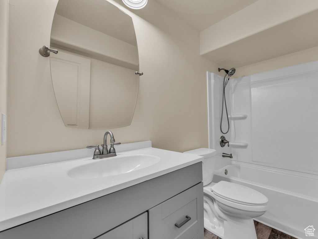 Full bath with vanity,  shower combination, and toilet