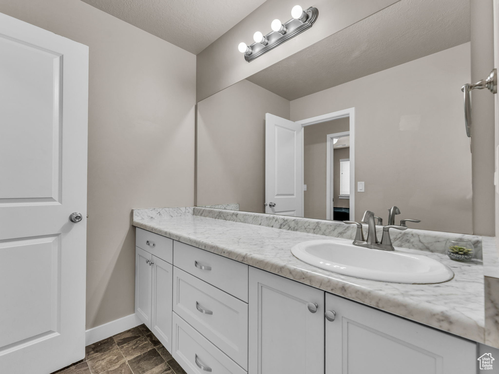 Bathroom featuring vanity and baseboards