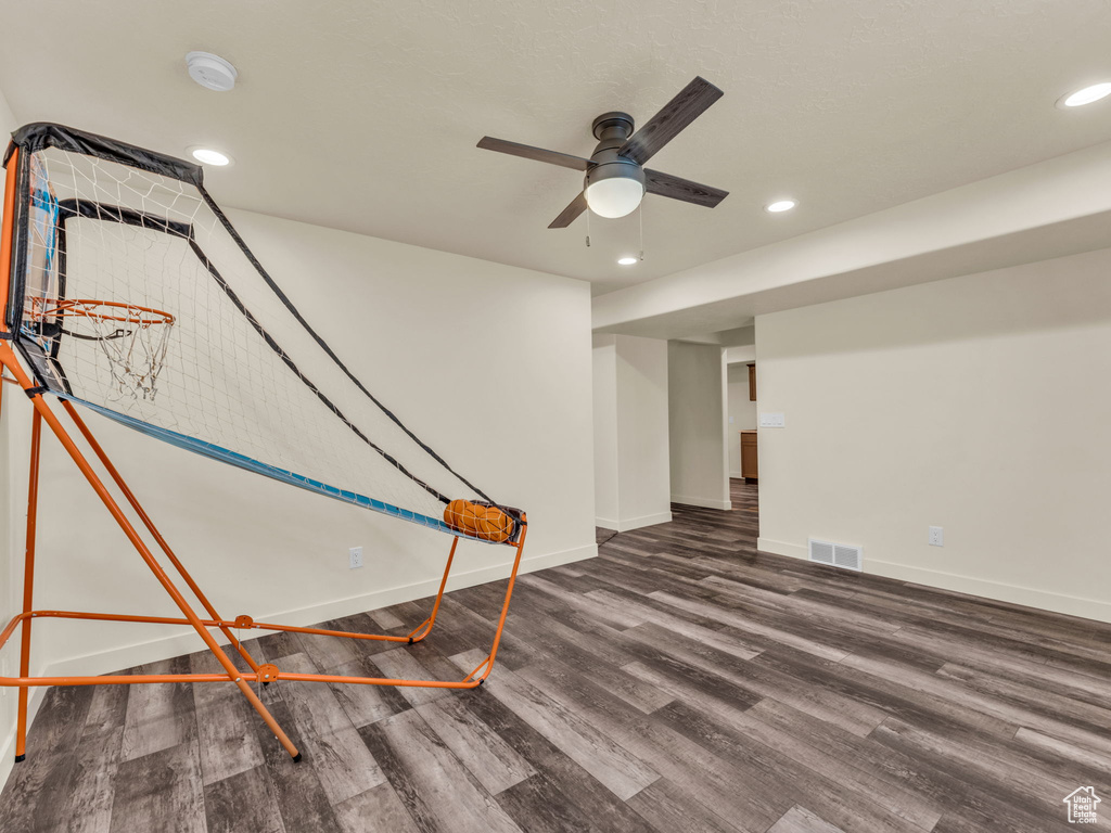 Basement featuring a ceiling fan, wood finished floors, baseboards, and recessed lighting