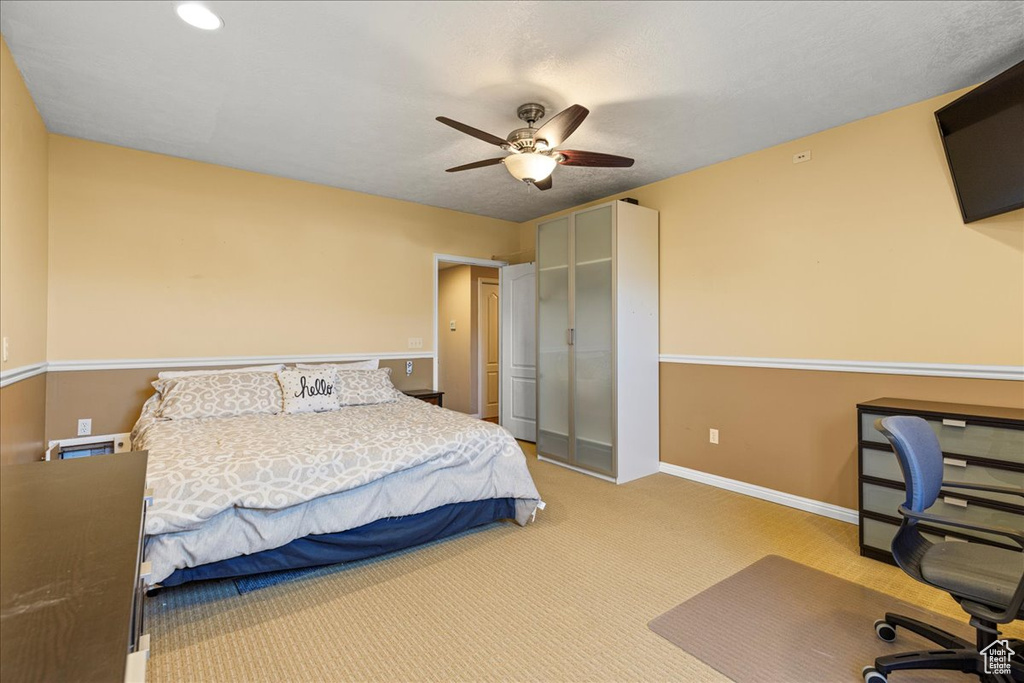 Carpeted bedroom featuring a desk, baseboards, ceiling fan, a closet, and recessed lighting