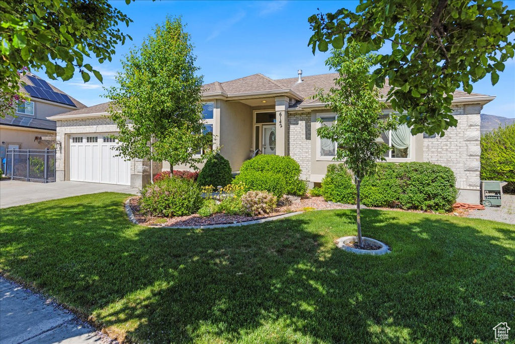 Obstructed view of property featuring concrete driveway and a garage