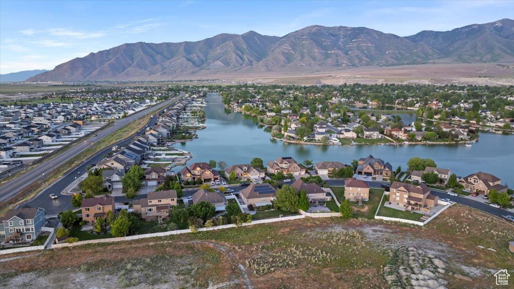 View of property location with a water and mountain view and nearby suburban area