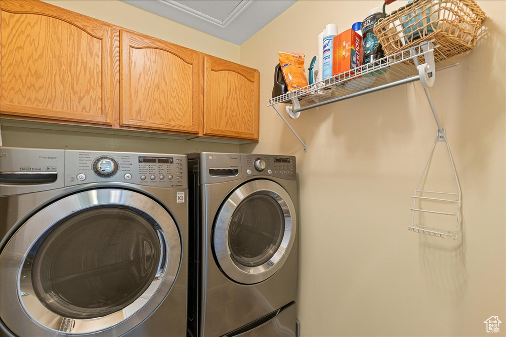 Laundry area with cabinet space and separate washer and dryer