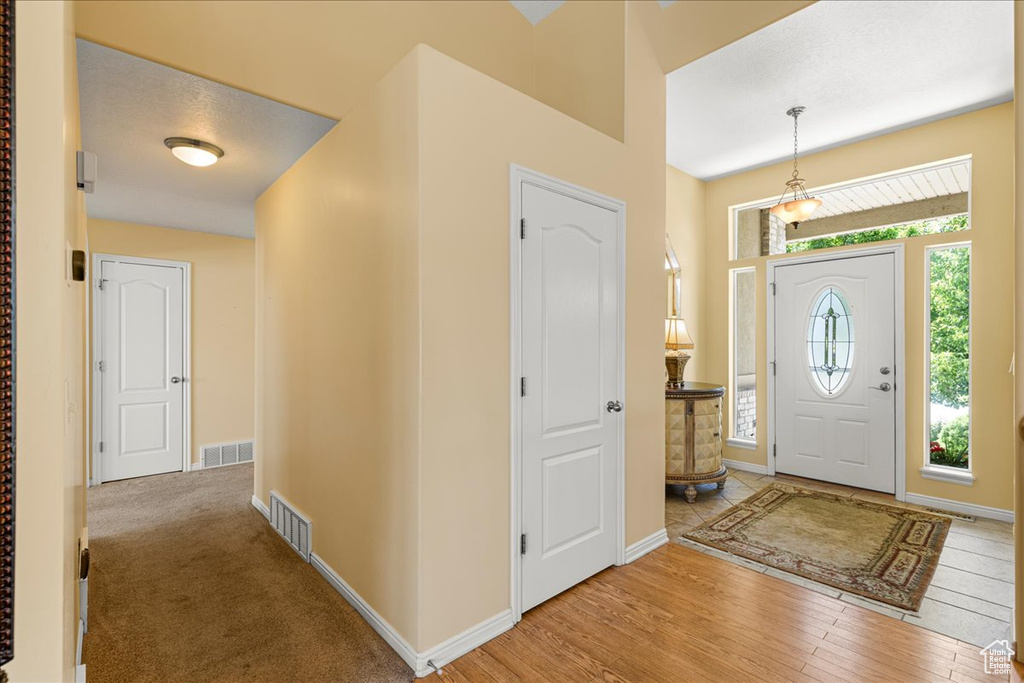 Entrance foyer featuring baseboards and wood finished floors