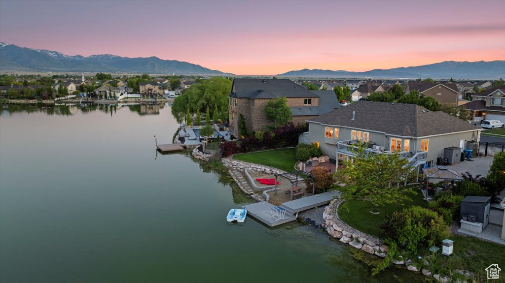 Aerial view at dusk of a water and mountain view and a residential view