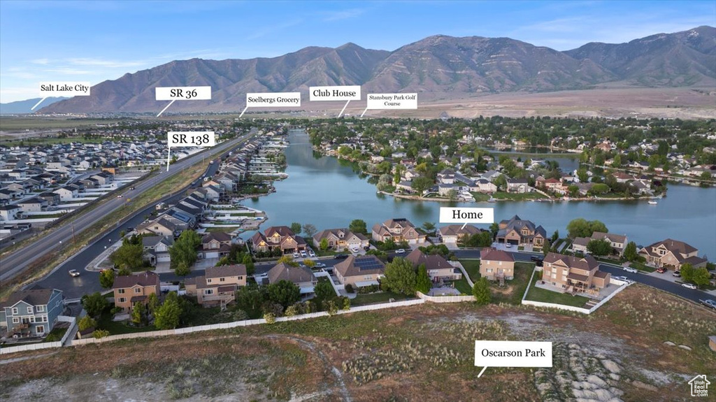 Aerial perspective of suburban area with a water and mountain view