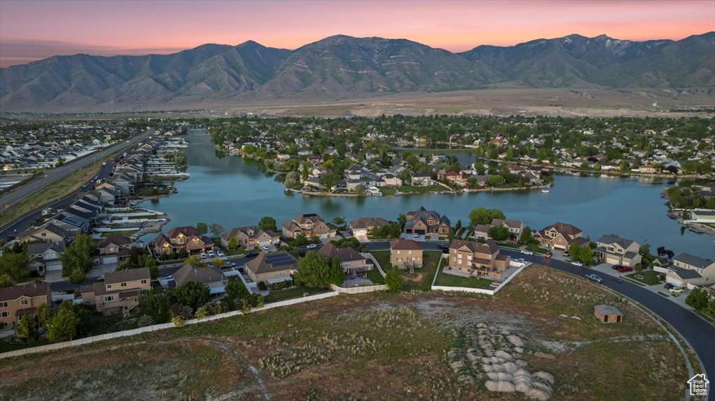 Aerial view at dusk of a water and mountain view and a residential view