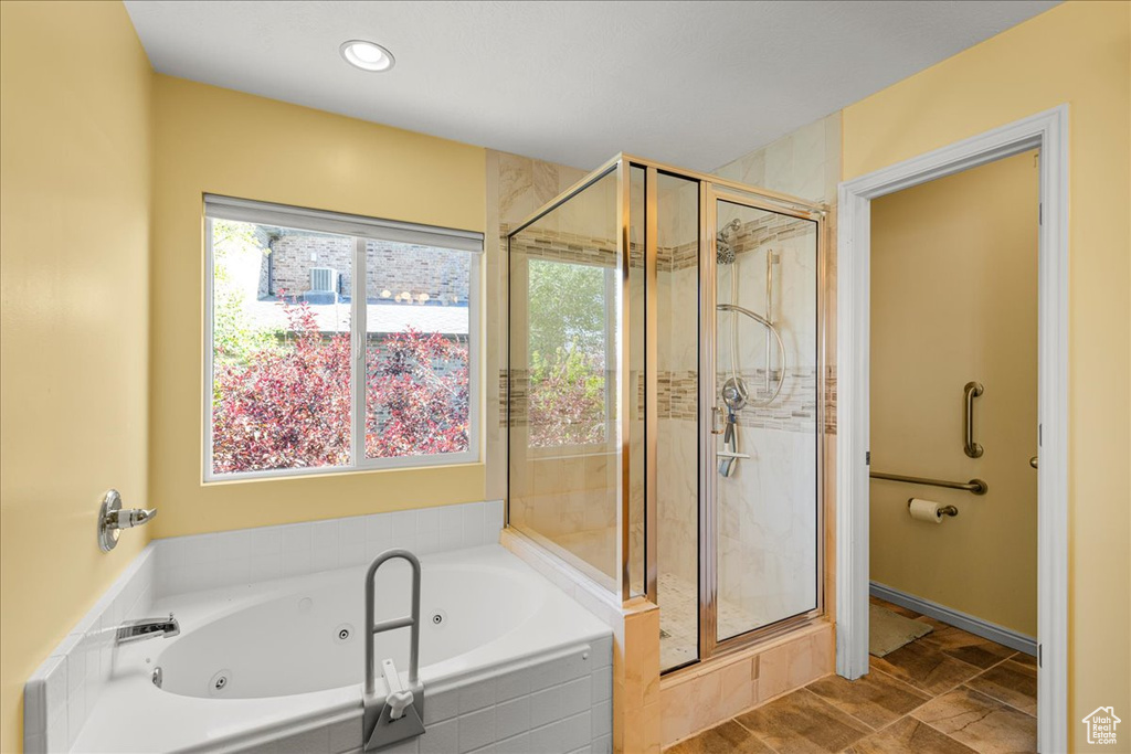 Full bathroom with a stall shower, a jetted tub, healthy amount of natural light, and recessed lighting
