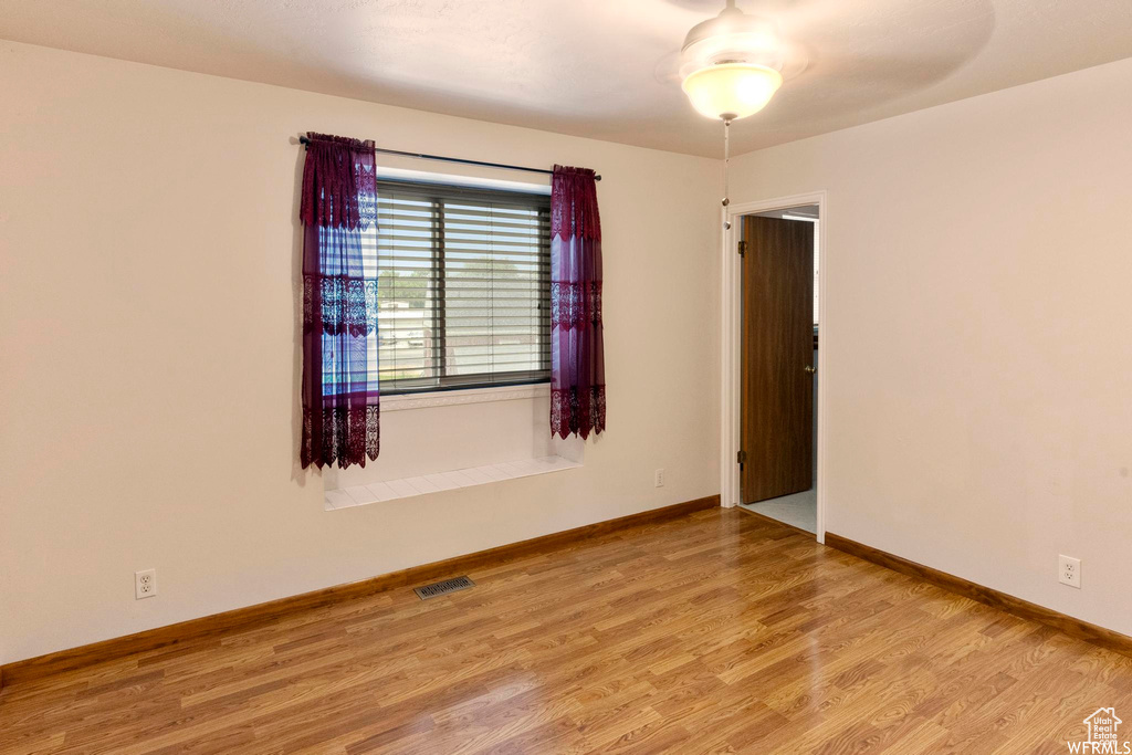 Spare room with wood finished floors and baseboards