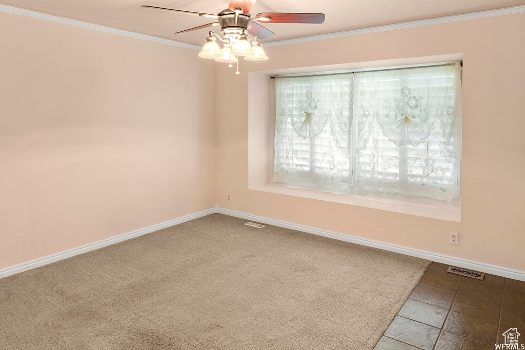 Unfurnished room with crown molding, ceiling fan, and baseboards