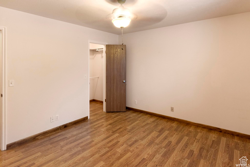 Empty room with light wood-type flooring and baseboards