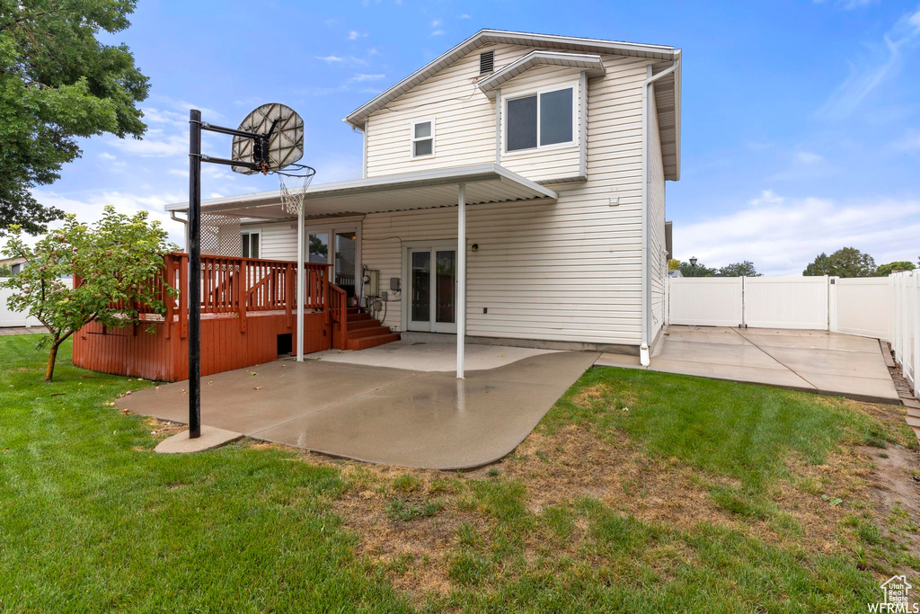 Back of house featuring a deck and a patio