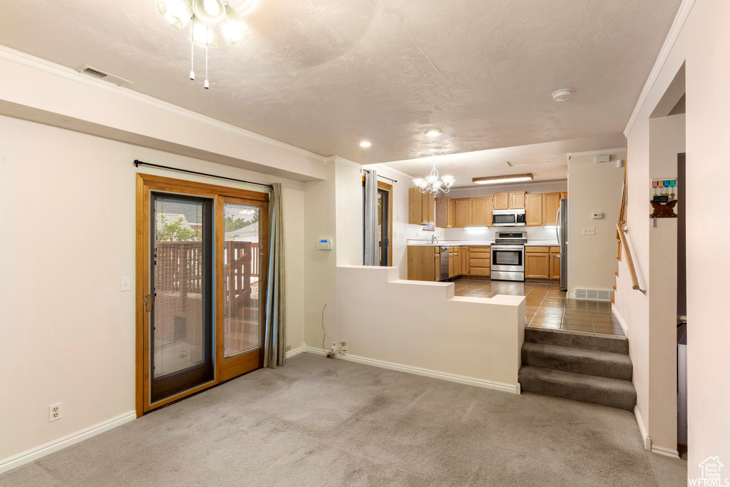 Unfurnished living room with baseboards, light carpet, recessed lighting, and stairway