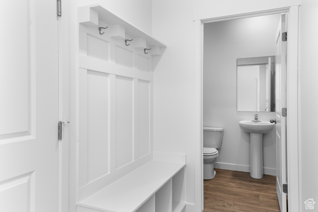 Mudroom with baseboards, dark wood-style flooring, and a sink