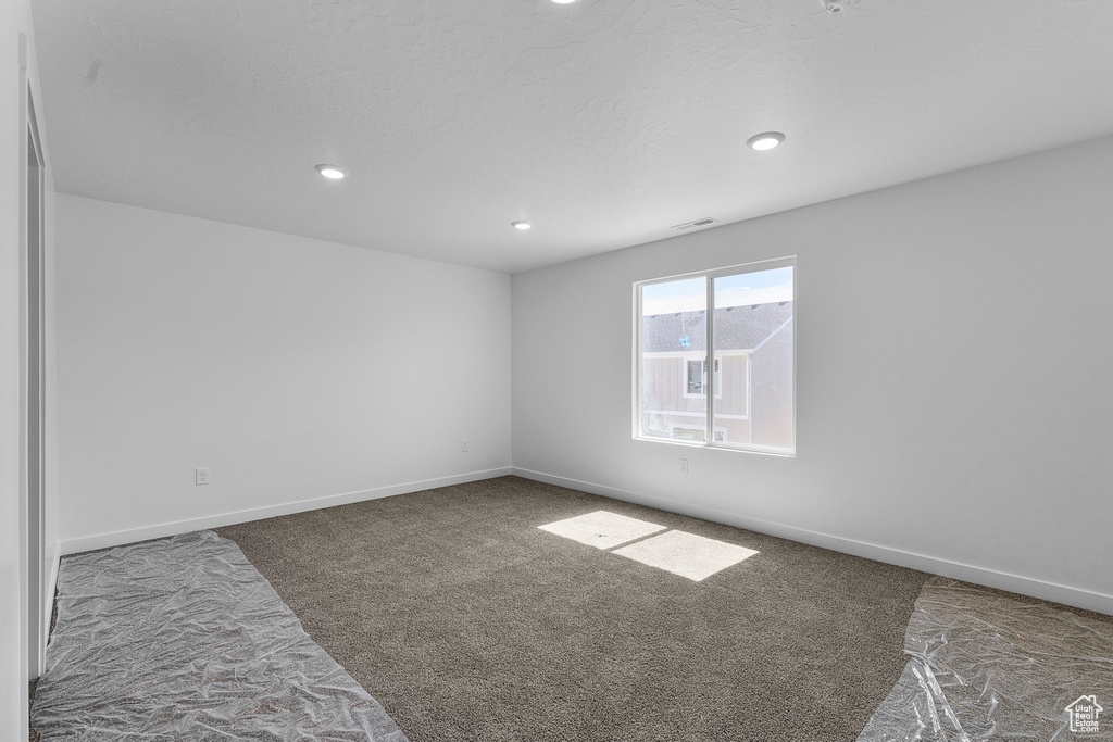 Unfurnished room featuring carpet flooring, recessed lighting, and baseboards