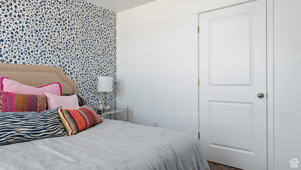 Bedroom featuring wallpapered walls
