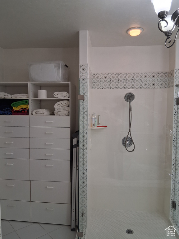 Bathroom with a shower stall and tile patterned flooring
