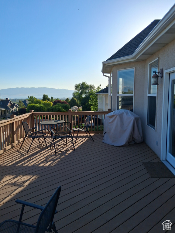 Wooden terrace featuring grilling area