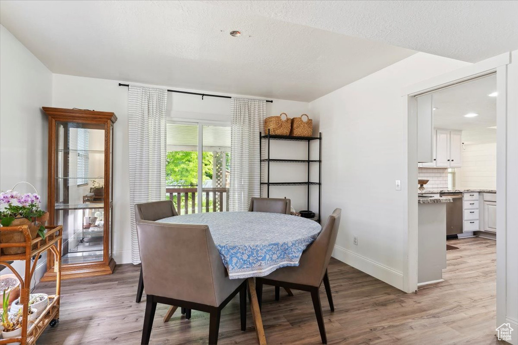 Dining room featuring light wood-style floors and baseboards