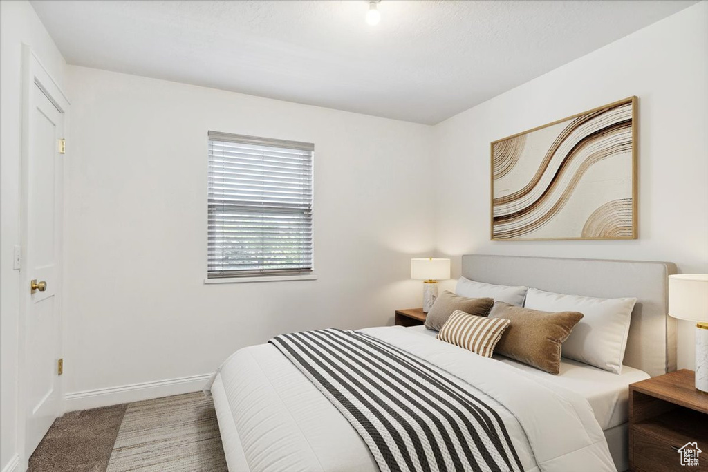 Carpeted bedroom featuring baseboards