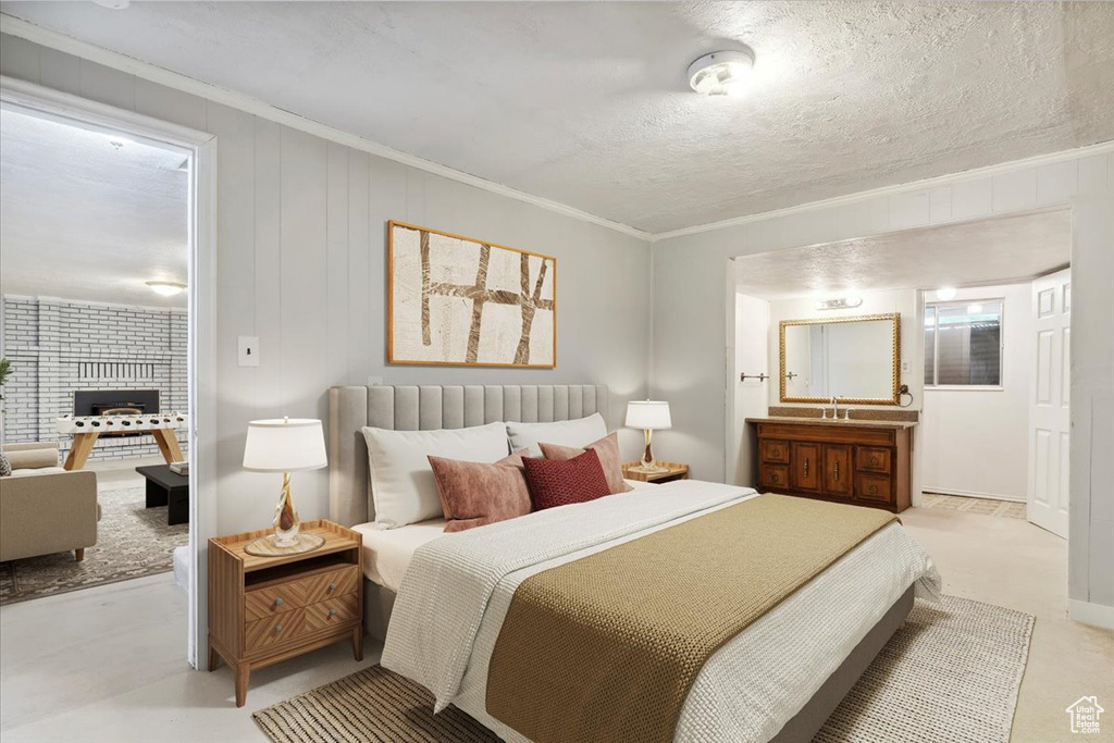 Bedroom with ornamental molding and a sink