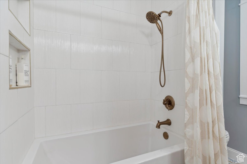 Full bathroom with shower / bathtub combination with curtain
