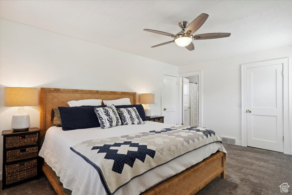 Bedroom with carpet, baseboards, and ceiling fan