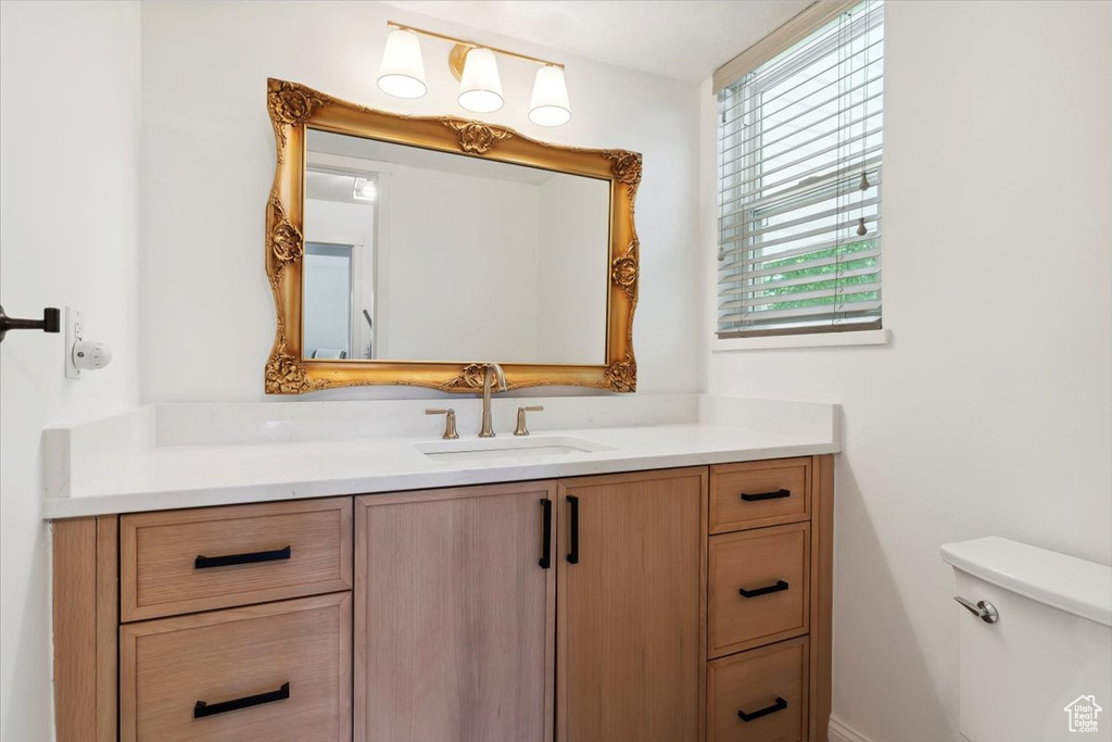Half bath with vanity and toilet