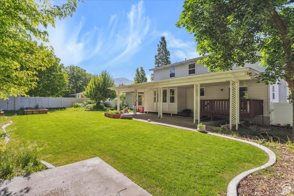 Rear view of property featuring a patio
