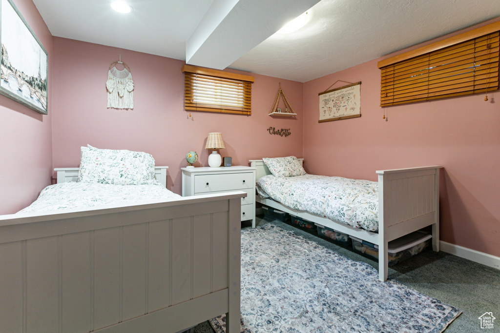 Carpeted bedroom featuring baseboards