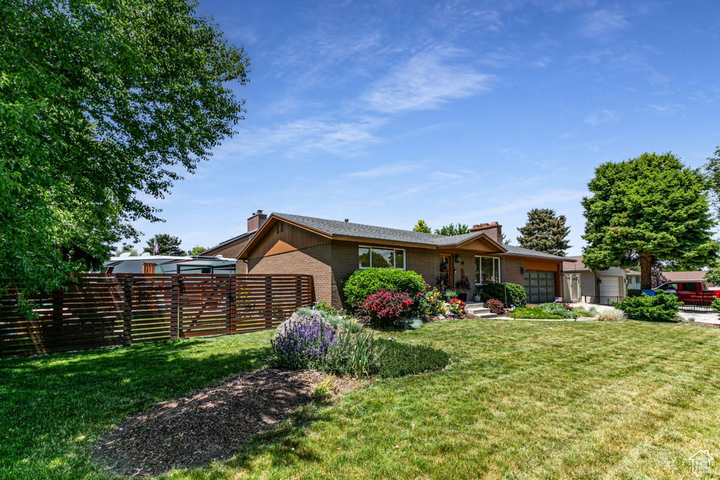 View of front of home featuring brick siding and a chimney
