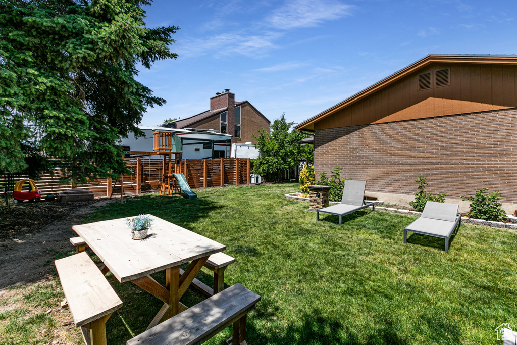 View of yard with a playground and outdoor dining space
